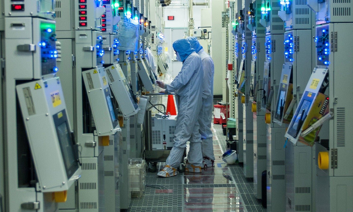 Two fabrication plant workers working at a terminal